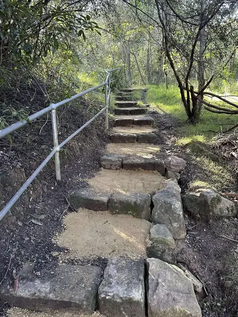 Restored sandstone bushland steps with safety handrail